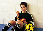 Boy eating a snack after soccer practice